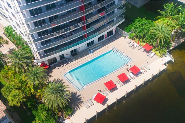 view of swimming pool with a water view and a patio