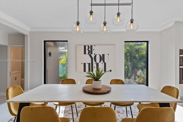 dining room featuring crown molding