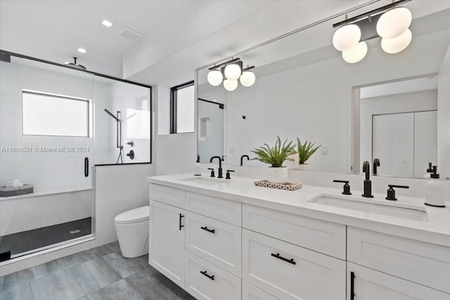 bathroom with toilet, vanity, and walk in shower