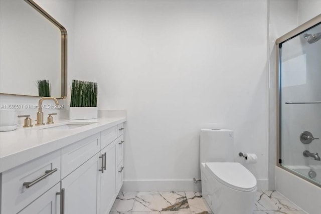 full bathroom with vanity, toilet, and shower / bath combination with glass door