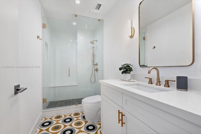 bathroom with vanity, a shower with shower door, and toilet