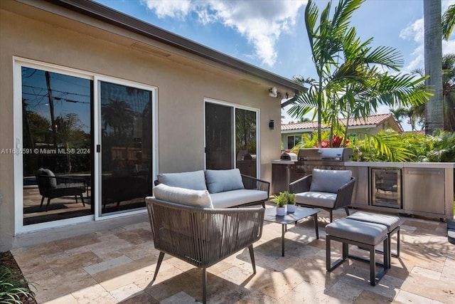 view of patio / terrace featuring area for grilling, an outdoor living space, and beverage cooler