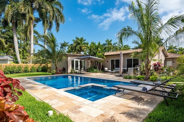 view of pool with an in ground hot tub and a patio