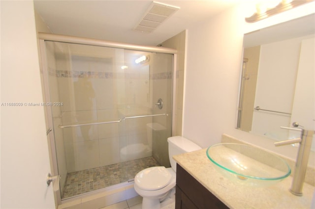 bathroom with walk in shower, tile patterned flooring, vanity, and toilet