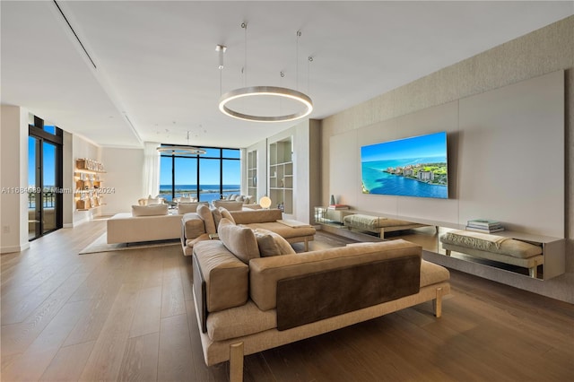 living room with expansive windows, wood-type flooring, and an inviting chandelier