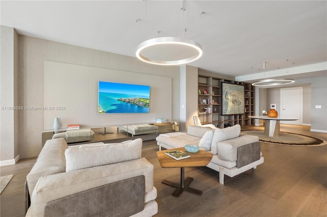 living room with built in features and hardwood / wood-style flooring