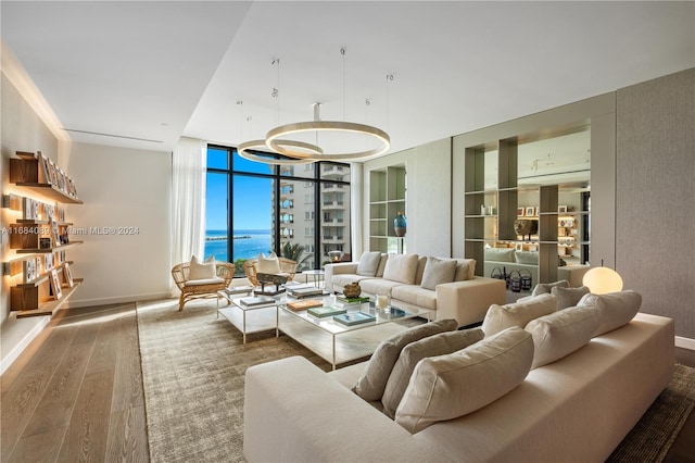 7065 Fisher Island Dr Unit 7065, Miami Beach, FL 33109 - living area featuring wood finished floors, baseboards, and a water view