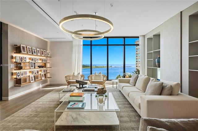 7065 Fisher Island Dr Unit 7065, Miami Beach, FL 33109 - living room with wood finished floors, a wall of windows, a water view, and baseboards