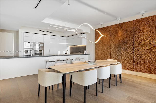 dining area featuring light hardwood / wood-style floors and sink