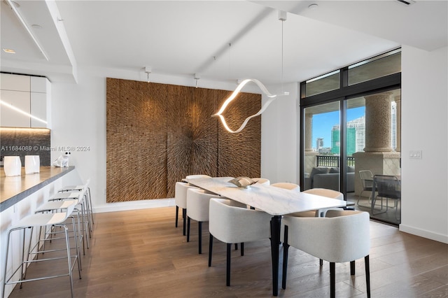 dining room with hardwood / wood-style flooring and floor to ceiling windows