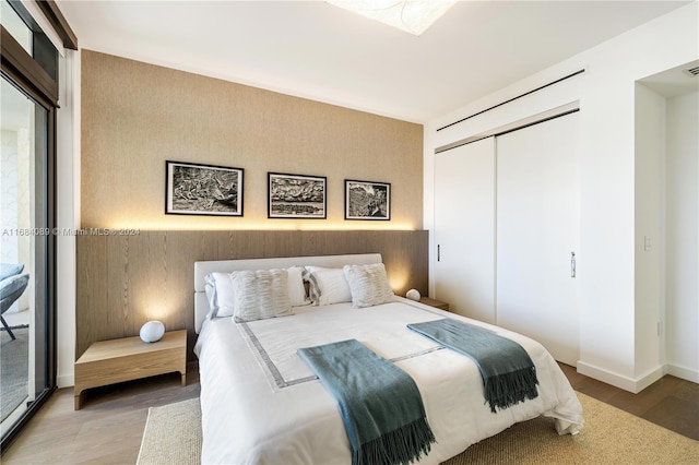 bedroom with a closet and light hardwood / wood-style flooring