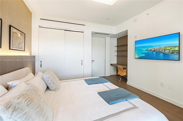 7065 Fisher Island Dr Unit 7065, Miami Beach, FL 33109 - bedroom featuring wood finished floors, a closet, and baseboards