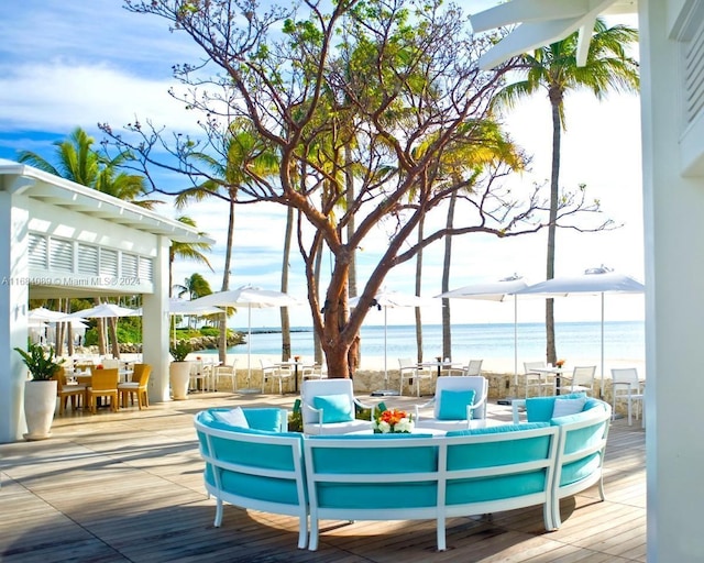 7065 Fisher Island Dr Unit 7065, Miami Beach, FL 33109 - wooden terrace with outdoor dining area, a water view, and an outdoor hangout area