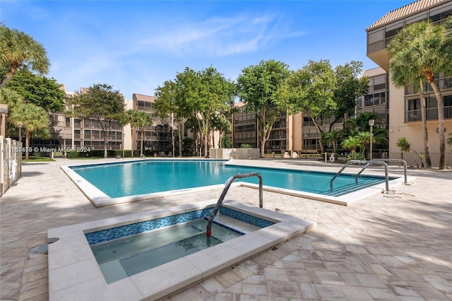 view of pool with a patio area and a community hot tub