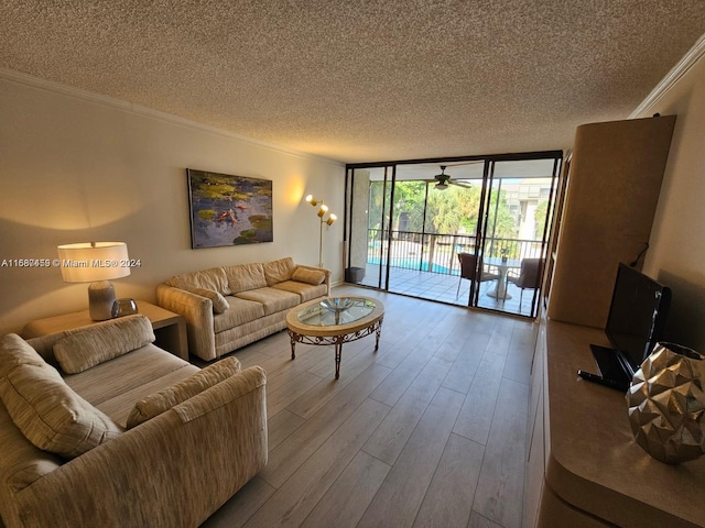 living room with a textured ceiling, hardwood / wood-style flooring, floor to ceiling windows, and crown molding