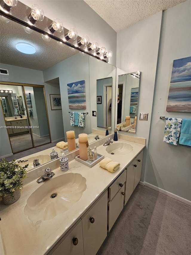 bathroom with vanity and a textured ceiling