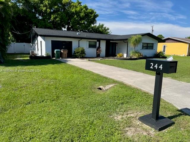 single story home with a front lawn and a garage