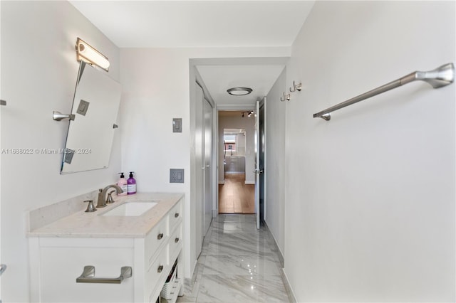 180 NE 12th Ave Unit 12E, Hallandale Beach, FL 33009 - bathroom featuring marble tiled floors, vanity, and baseboards