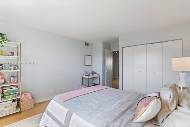 180 NE 12th Ave Unit 12E, Hallandale Beach, FL 33009 - bedroom with wood finished floors, a closet, and baseboards