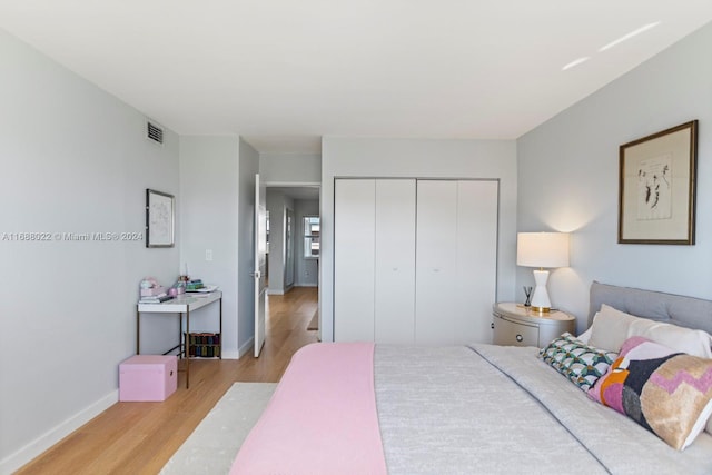 180 NE 12th Ave Unit 12E, Hallandale Beach, FL 33009 - bedroom with light wood-type flooring, a closet, and baseboards