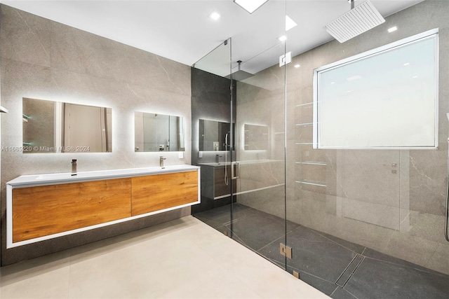 bathroom featuring a shower with shower door, vanity, and tile patterned flooring