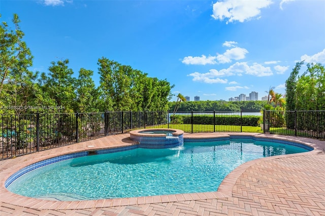 view of pool featuring an in ground hot tub