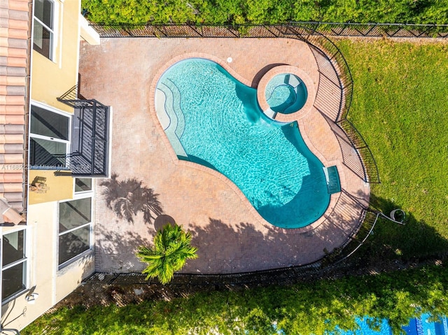 view of pool with a patio and a lawn