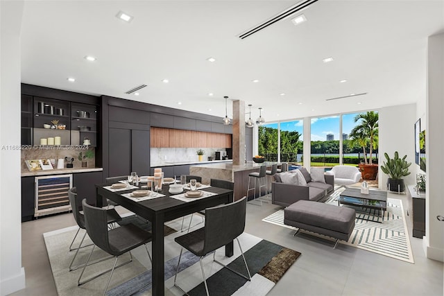 dining space with expansive windows and beverage cooler