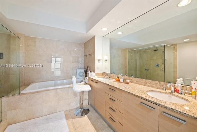 bathroom featuring tile patterned flooring, vanity, and independent shower and bath