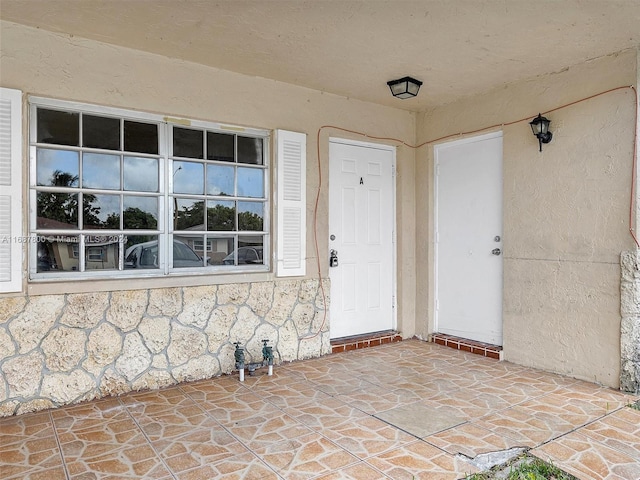 property entrance featuring a patio area