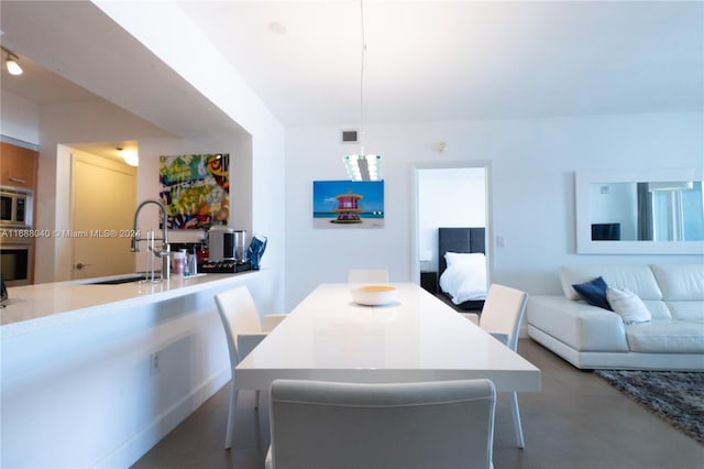 dining area with concrete floors and sink