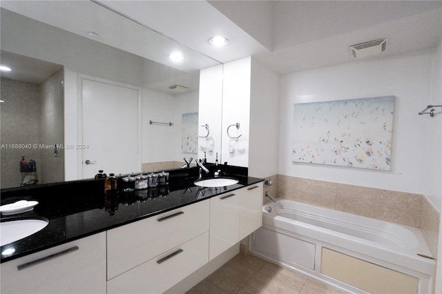 bathroom with vanity, tile patterned flooring, and a bathing tub