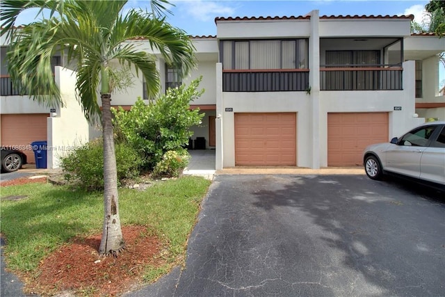 view of front of house with a garage and a balcony