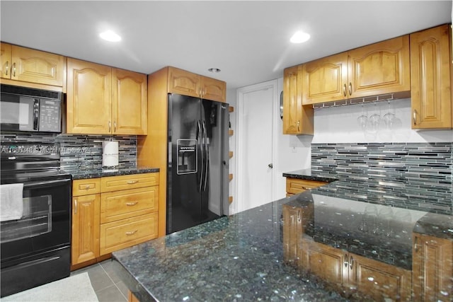 kitchen with dark stone countertops, light tile patterned floors, black appliances, and decorative backsplash