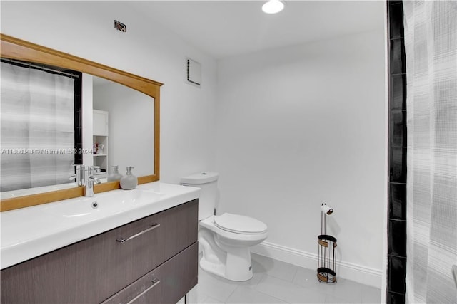 bathroom with toilet, a shower with curtain, vanity, and tile patterned flooring