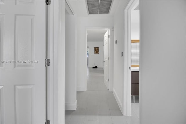 corridor with light tile patterned floors