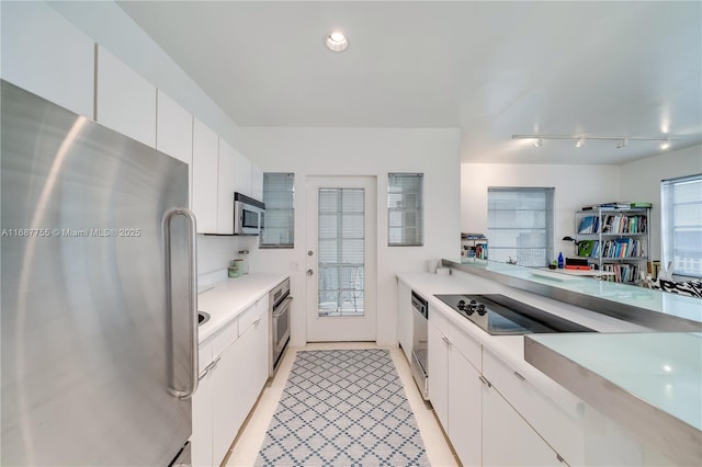 kitchen featuring stainless steel appliances and white cabinets