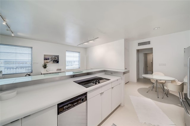 kitchen with stainless steel dishwasher, white cabinetry, black electric stovetop, and rail lighting