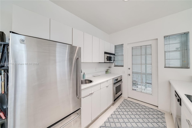 kitchen featuring white cabinets and appliances with stainless steel finishes