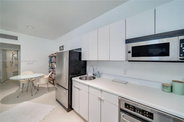 kitchen with white cabinets, sink, and appliances with stainless steel finishes