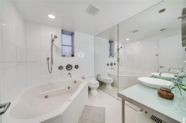 full bathroom with a bidet, tile patterned floors, tiled shower / bath combo, sink, and toilet