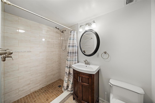 bathroom featuring a shower with shower curtain, vanity, and toilet