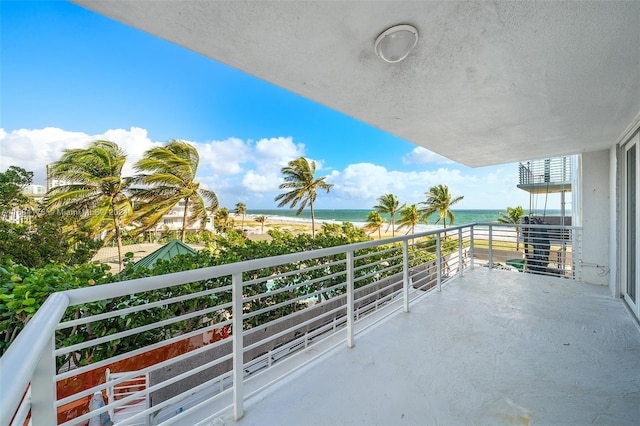 balcony with a beach view and a water view