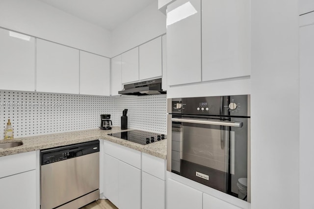 kitchen featuring tasteful backsplash, appliances with stainless steel finishes, light stone counters, and white cabinets