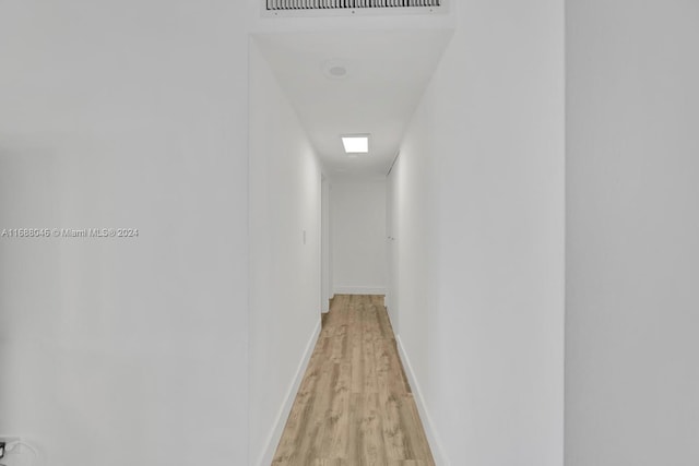 corridor with light wood-type flooring