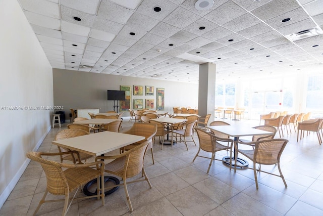 tiled dining area featuring a wealth of natural light and a paneled ceiling