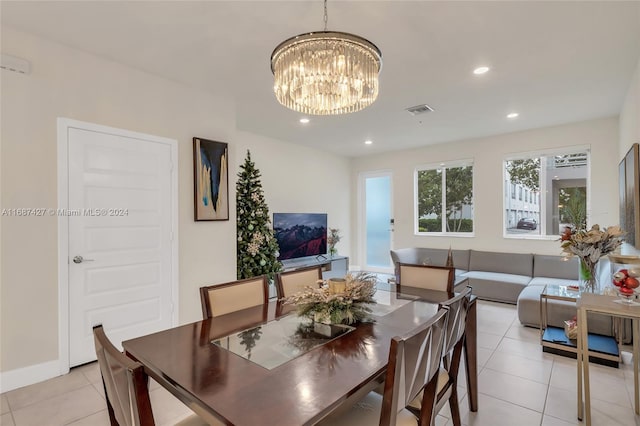 tiled dining space with an inviting chandelier