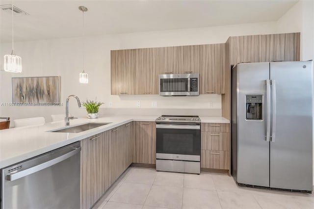 6425 NW 103rd Pl Unit 102, Doral, FL 33178 - kitchen featuring stainless steel appliances, a sink, light countertops, and modern cabinets