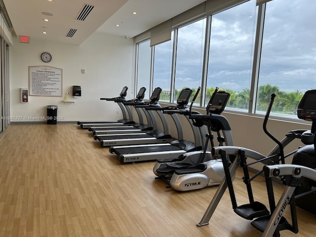 6425 NW 103rd Pl Unit 102, Doral, FL 33178 - exercise room with wood finished floors, baseboards, and recessed lighting