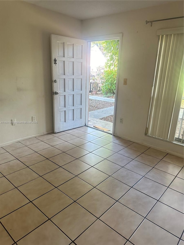 doorway with light tile patterned floors